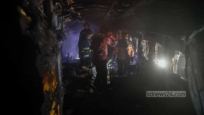 Fire Service personnel search for survivors or bodies after an arson attack on Benapole Express at Gopibagh in Dhaka on Friday night, Jan 5, 2024.