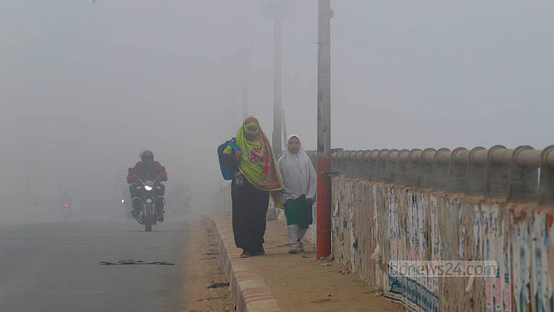 A child is on the way to school with her mother through dense fog early in the morning on Wednesday, Jan 24, 2024.
