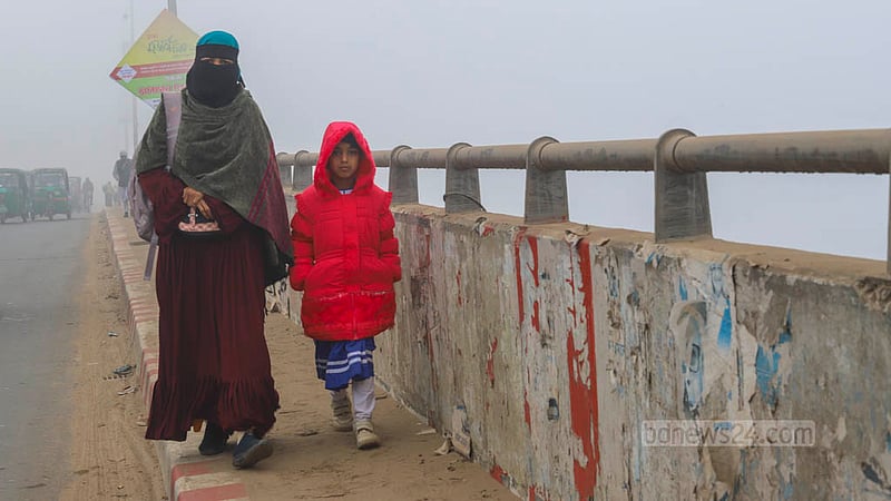 A child is on the way to school with her mother through dense fog early in the morning on Wednesday, Jan 24, 2024.