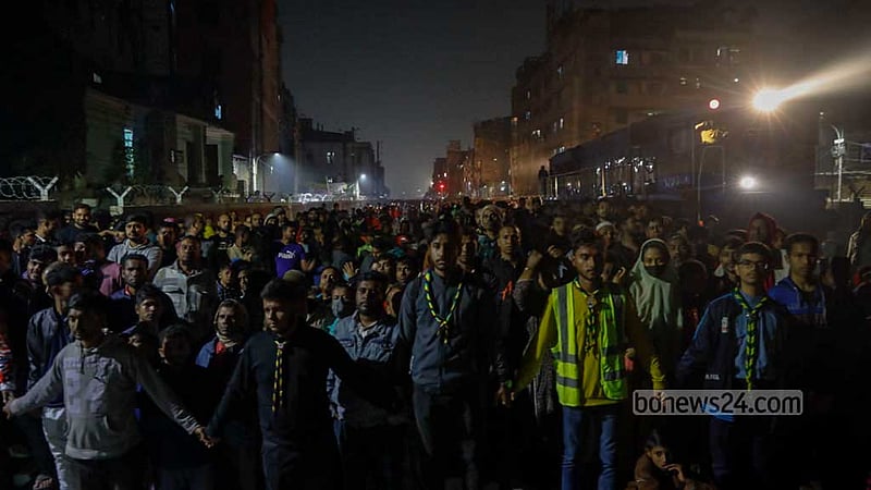 Onlookers gather after an arson attack on Benapole Express at Gopibagh during the train’s entry into Dhaka on Friday night, Jan 5, 2024, the eve of the BNP’s hartal, or shutdown, aimed to disrupt the Jan 7 vote.