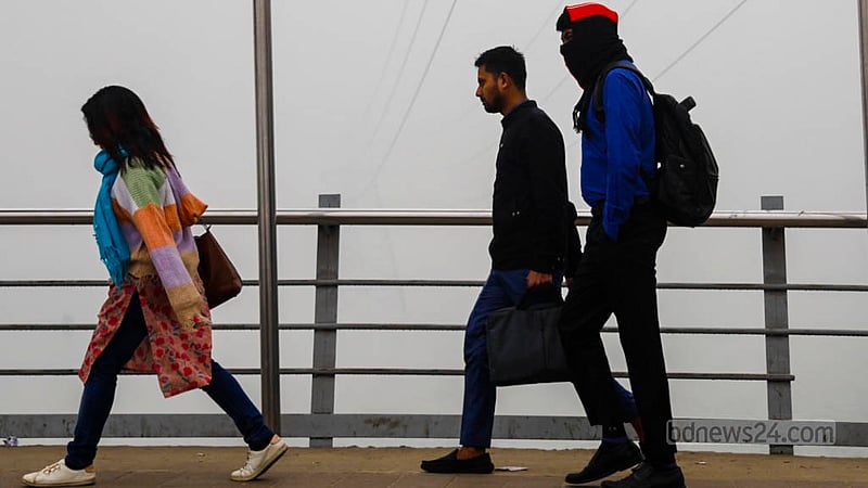City dwellers making their way through dense fog on a winter morning. Photo captured in Dhaka's Hatirjheel area on Wednesday, Jan 24, 2024.