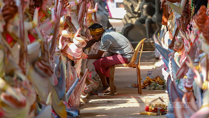 Bakul Sarker, an artisan from Gopalganj, gives a makeover to idols of Saraswati, the Hindu goddess of wisdom and learning, at Ramna Kali Temple in Dhaka.