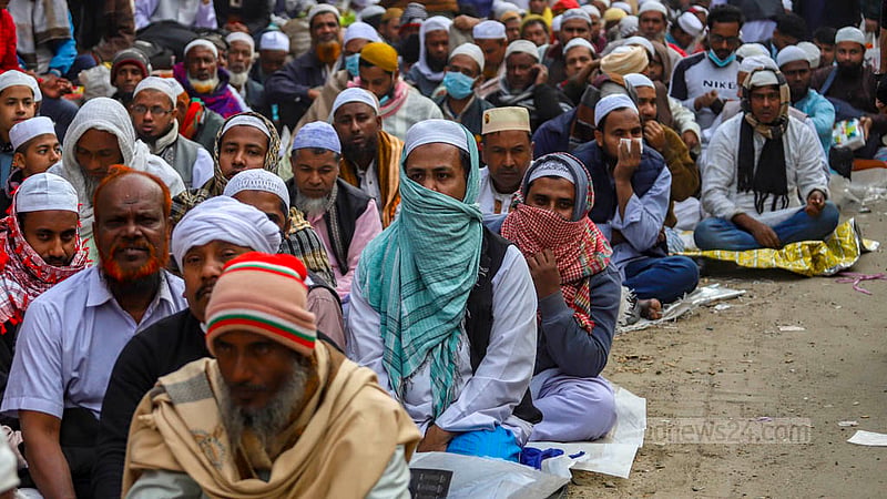 Muslim devotees sit on Tongi Station Road on Sunday, Feb 4, 2024, waiting to take part in the Bishwa Ijtema Akheri Munajat.
