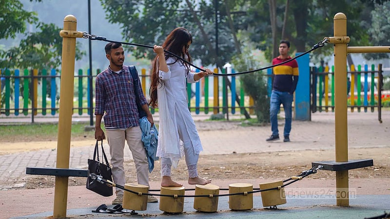 Adults occupy the rides at the children's play area in Dhaka's Ramna Park.