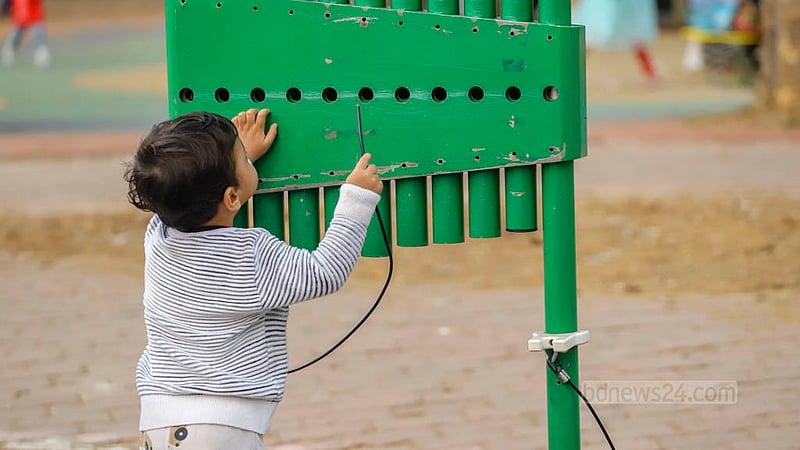 In Ramna Park's Children's Corner, a child searches for the missing mallets of a xylophone.