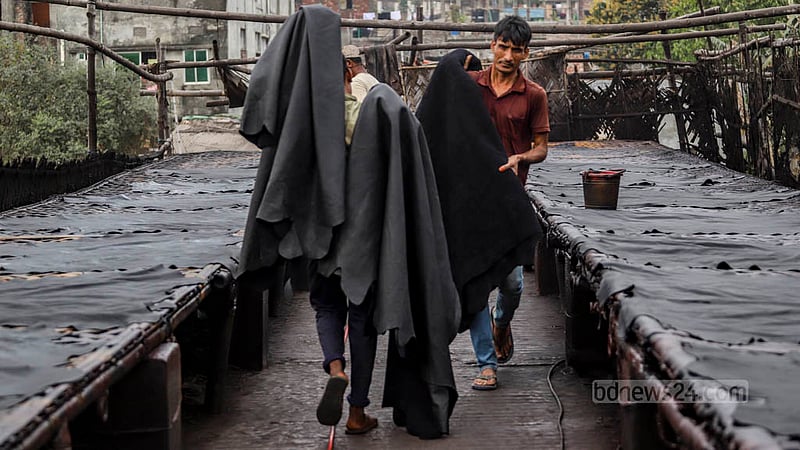 Workers apply dye on leathers at a factory in Dhaka’s Hazaribagh.