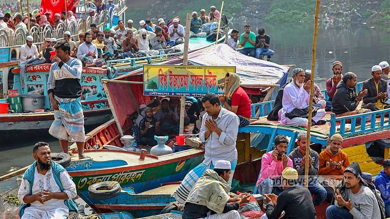 People take part in the Akheri Munajat to close out the second phase of the Bishwa Ijtema from a boat on the Turag River on Sunday, Feb 11, 2024.