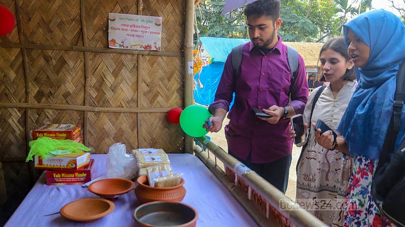 Visitors browse the displays of sweets at the National Sweets Fair at the Bangladesh Shilpakala Academy premises on Thursday, Mar 7, 2024.