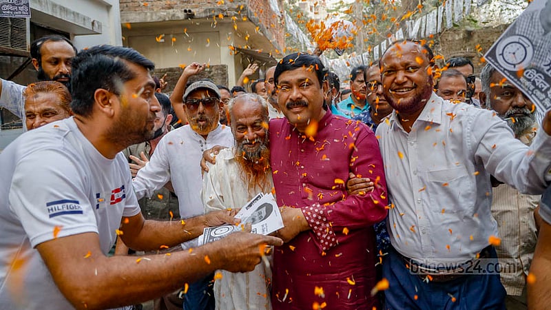 Monirul Haque Sakku, a mayor candidate in the Cumilla City Corporation by-polls, hands out leaflets ahead of the election.