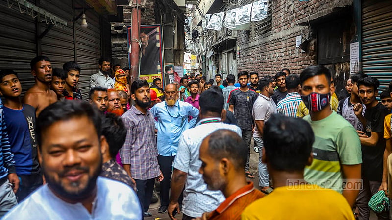 Onlookers gather after a shoe factory in Old Dhaka’s Swarighat catches fire on Monday, Mar 11, 2024.
