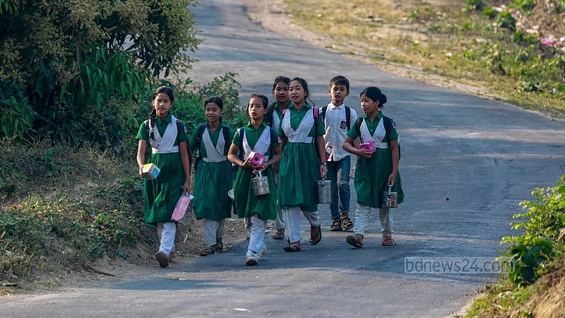 Children of the Mro tribe return home from school on foot along the Chimbuk Hill road in the hill district of Bandarban. The children sometimes have to walk for over two hours every day from their homes in Jamini Para to get to and from school.