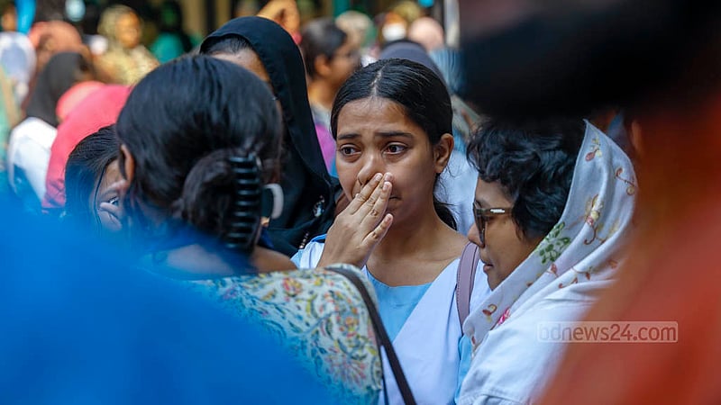 A student of Viqarunnisa Noon School and College breaks into tears during the funerals of teacher Lutfun Nahar Karim Lucky and her daughter Jannatin Tajri Nikita, a former student of the institution, after their deaths in a fire at a restaurant building on Bailey Road.