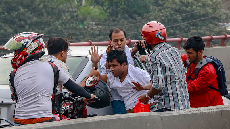 A confrontation occurs between a motorcyclist and a private car driver during a traffic jam on the Mayor Mohammad Hanif Flyover in Dhaka.