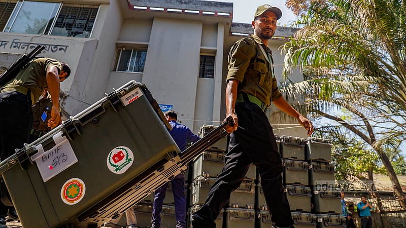 A member of the Ansar force uses a trolley cart to move an electronic voting machine after the distribution of election materials for Cumilla City Corporation mayoral by-election at Cumilla Zilla School on Friday, Mar 8, 2024.