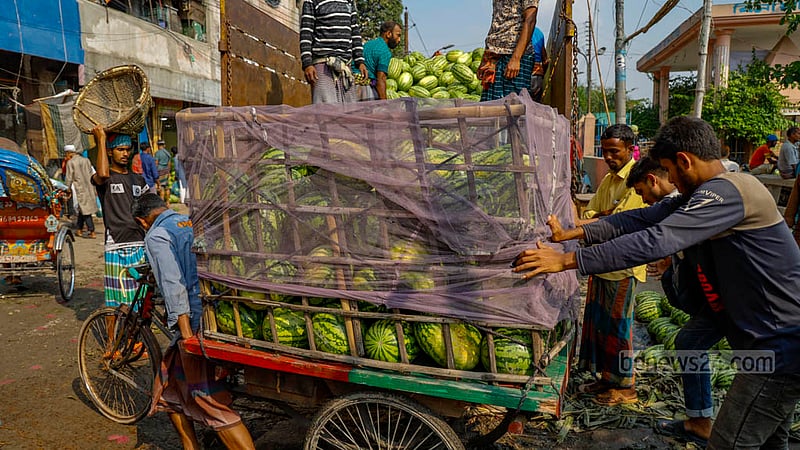 A rickshaw van loaded with watermelons sets off for another marketplace from Dhaka’s Waisghat.