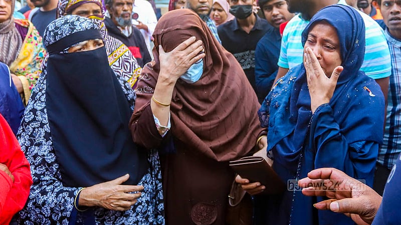Relatives break down in tears as they receive the bodies of five members of the family at the morgue of Dhaka Medical College Hospital after the Bailey Road building fire.