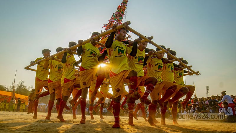 Young people from minority ethnic communities dance along to the rhythm of musical instruments as they carry a symbolic coffin of the late Mahathero during the funeral ceremony. They believe the performance will allow the departed soul of Mahathero to reach heaven.