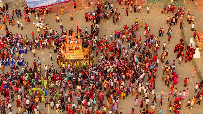 The body of the monk Mahathero is placed in a room decorated with sandalwood and wrapped in colourful papers.