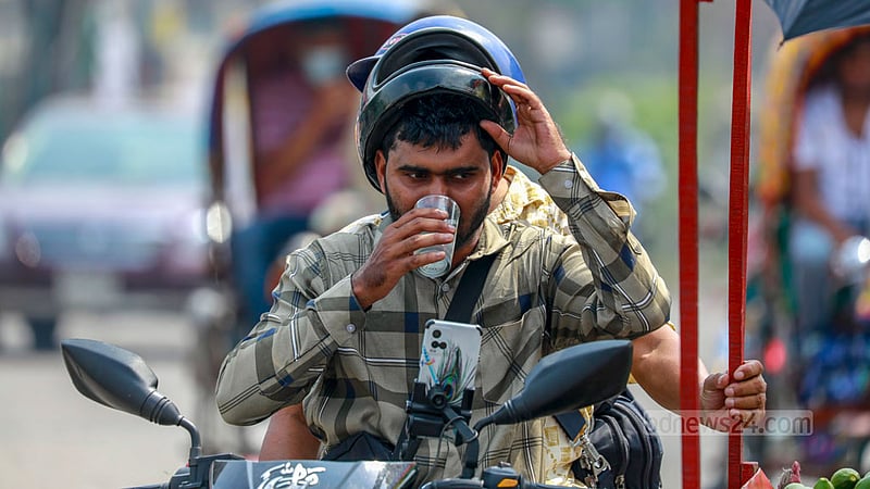 In the scorching Baishakh afternoon, a motorbiker seeks respite by indulging in a refreshing sherbet.