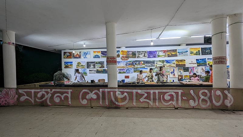 Painters work on paintings for display and sale at the Dhaka University Faculty of Fine Art amid preparations for the Mangal Shobhajatra procession.