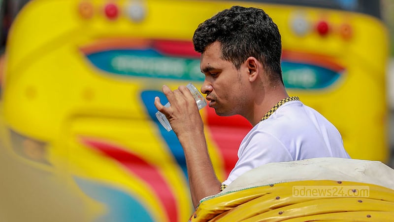 Amidst the oppressive summer heat, a rickshaw passenger in Dhaka's Rampura finds solace by sipping on sherbet during the hot afternoon.