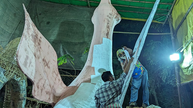 Artists and artisans work on a float for the Mangal Shobhajatra procession at the Dhaka University Faculty of Fine Art.