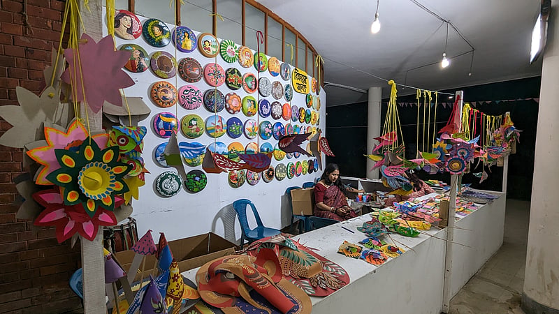 Bowls, masks, and other items are put on display and sale at the Dhaka University Faculty of Fine Art amid preparations for the Mangal Shobhajatra procession.