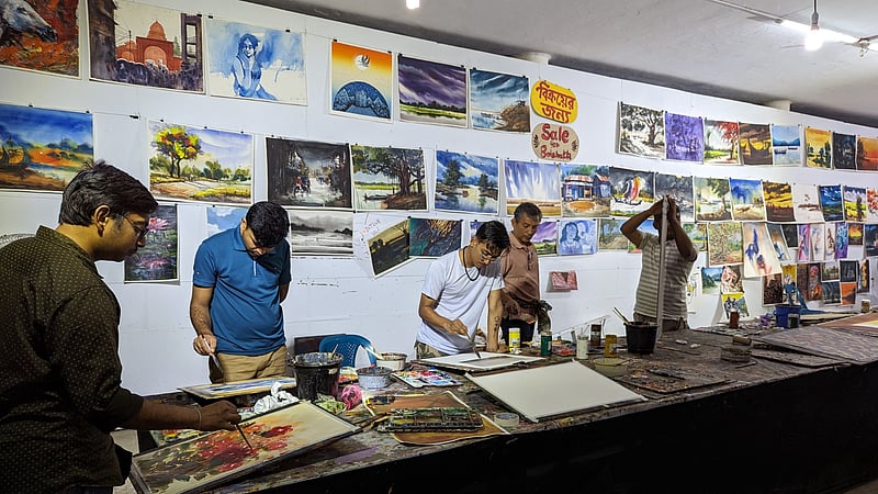 Painters work on paintings for display and sale at the Dhaka University Faculty of Fine Art amid preparations for the Mangal Shobhajatra procession.