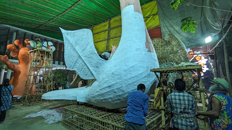 Artists and artisans work on a floats for the Mangal Shobhajatra procession at the Dhaka University Faculty of Fine Art.