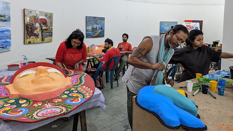 Artists work on masks amid preparations for the Mangal Shobhajatra procession at the Dhaka University Faculty of Fine Art.