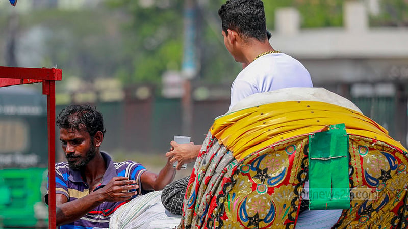 A rickshaw puller in Dhaka's Rampura offers sherbet to his passenger for relief from the afternoon heat of Baishakh.