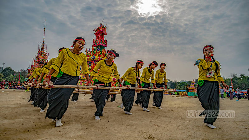 Young people from various parts of the Chattogram Hill Tracts perform dances wearing various costumes during the funeral ceremony of the late Mahathero.