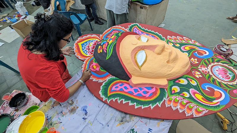 An artist paints a mask for the Mangal Shobhajatra procession at the Dhaka University Faculty of Fine Art.