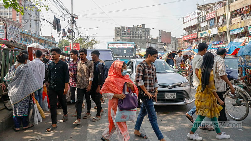 Commuters dare to dodge moving vehicles in a bid to cross the street outside Dhaka’s New Market despite putting the lives of road users at risk.