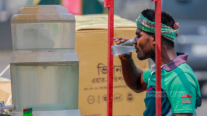 A three-wheeler driver soothes himself in the blistering afternoon heat by quenching his thirst with sherbet.