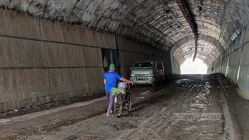 Water dripping from the walls of the Bandarban Bus Terminal Tunnel has created potholes, leaving the interior muddy. Both people and vehicles still struggle to pass through it. Photo: U She Thowai Marma