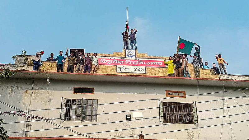 Students hoist a banner reading “Titumir University” at the main gate and administrative building of the college campus on Tuesday, Jan 7, 2025, to demand an independent university.  Photo: Abdullah al Momin