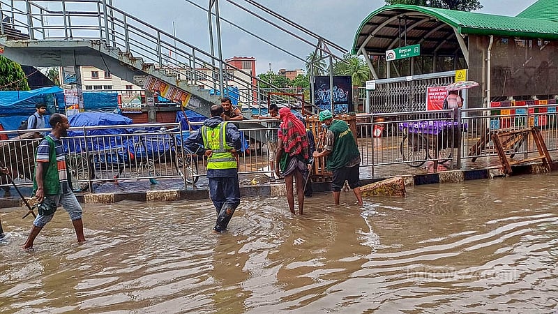 City Corporation workers attempt to drain water from the submerged road under the Mirpur-10 Metro Station after the heavy rainfall on Tuesday morning, Sept 3, 2024. Photo: Obaidur Masum