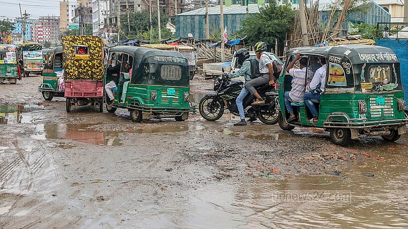 Pedestrians face severe inconvenience while crossing the damaged sections of the road from Hasnabad to Pangaon Container Terminal. Photo: Abdullah Al Momin