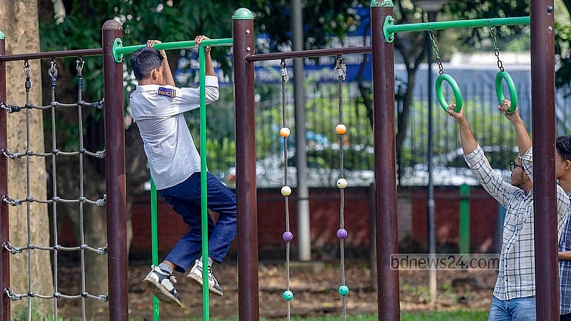 Adults use playground equipment meant for children in the designated play area at Ramna Park in Dhaka. Photo: Mahmud Zaman Ovi