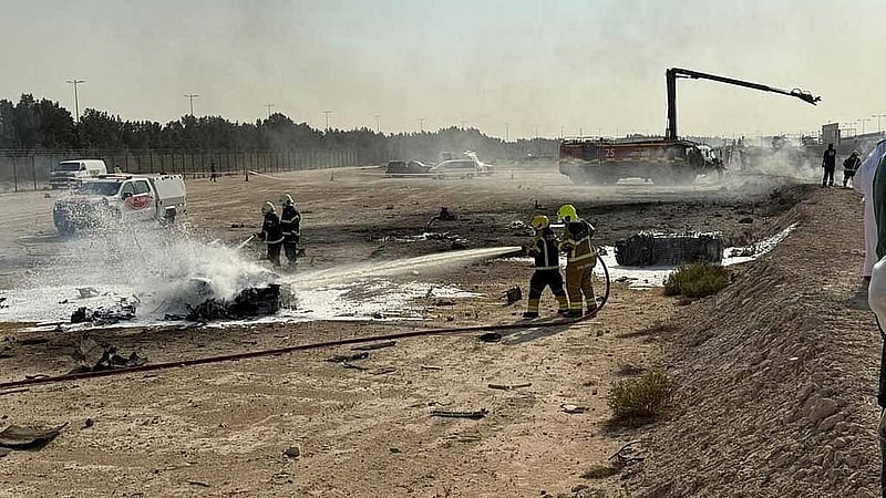 Firefighters work at the site of a crash involving an Indian-made HAL Tejas fighter jet at the Dubai Air Show, United Arab Emirates, November 21, 2025, in this handout picture obtained from social media. Government of Dubai Media Office/Handout via REUTERS 
