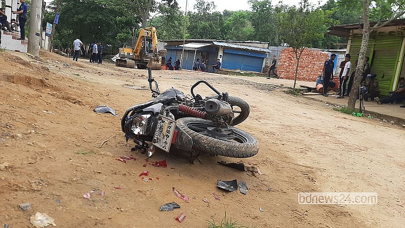A damaged motorcycle was seen lying beside a road on Monday, May 25, 2026, following overnight gunfire between joint forces and attackers in Chattogram’s Jungle Salimpur.  Photo: Suman Babu