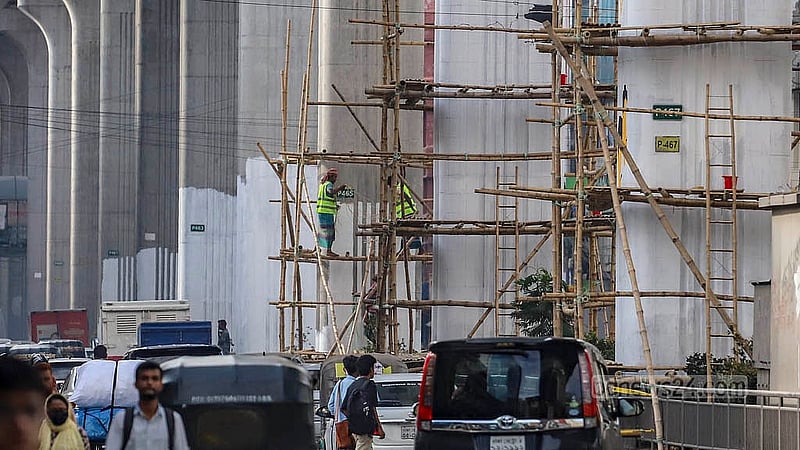 The pillars of the metro rail from Dhaka’s Karwan Bazar to Farmgate are being painted white on Saturday, Jul 5, 2025, to create a base for graffiti illustrating the irregularities, occupation, oppression, and torture carried out by the “fascist” Awami League government. Photo: Abdullah al Momin