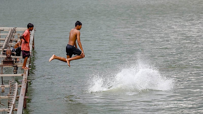 Children jump over the fountain in the middle of the lake at Zia Udyan. Photo Mahmud Zaman Ovi