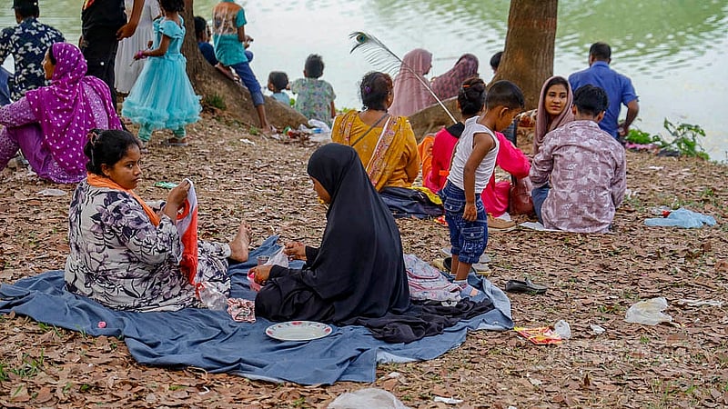 Many people who visit the National Zoo during the Eid holidays spend time sitting on the fallen leaves; some have brought their families and food. Photo: Mahmud Zaman Ovi