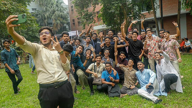 Jubilant Notre Dame College students take selfies to capture the moment after receiving their HSC results on Thursday, Oct 16, 2025. Photo: Abdullah Al Momin