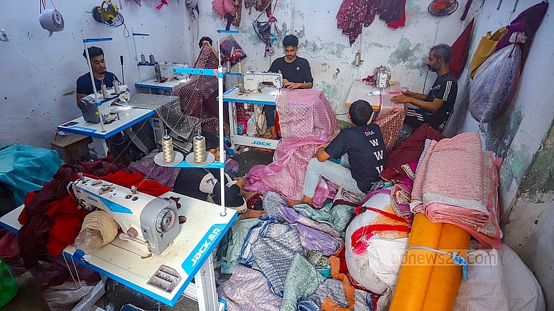 Artisans at Benarasi Palli in Dhaka’s Mirpur are attaching lace to sarees of different designs. Photo: Abdullah al Momin
