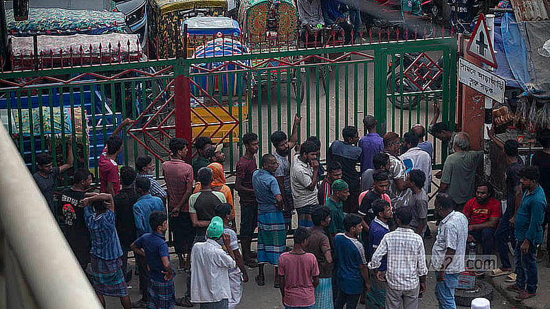 Outside the main gate of the Postogola dumping station, large crowds gather daily, waiting to reclaim their seized vehicles. Photo: Abdullah Al Momin