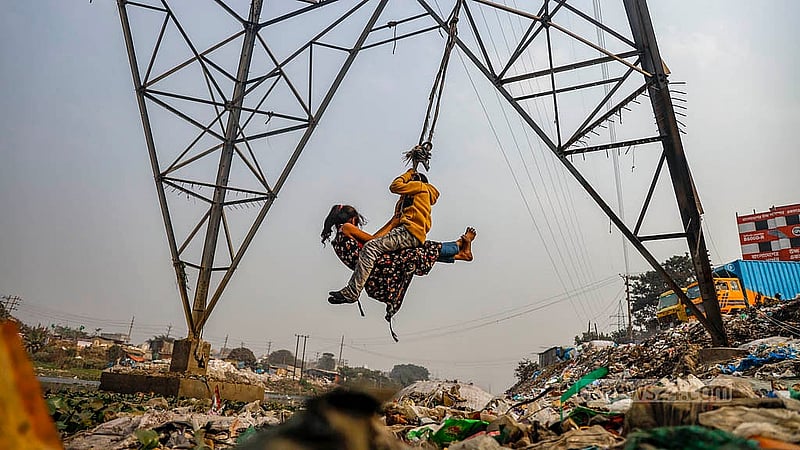 With no playgrounds or recreational centres in Kamrangirchar, children spend their time after school playing along the riverbank amid piles of waste and garbage. Photo:  Mahmud Zaman Ovi