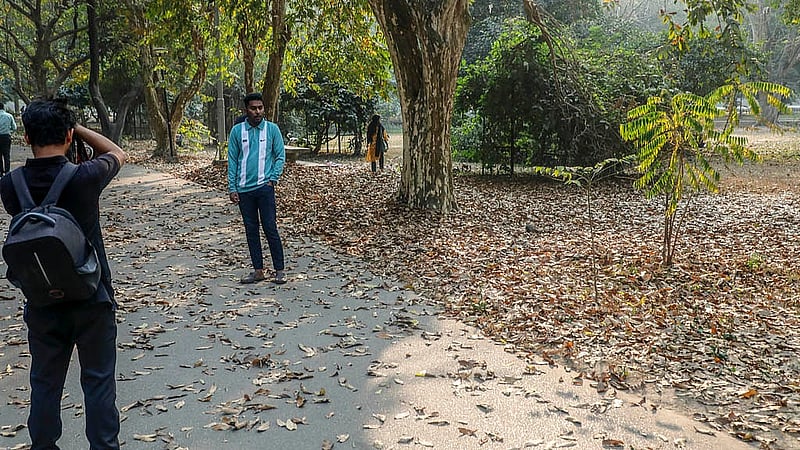 Many pause to capture the moment on camera, photographing themselves amid the falling leaves as winter gives way to spring.  Photo: Abdullah al Momin